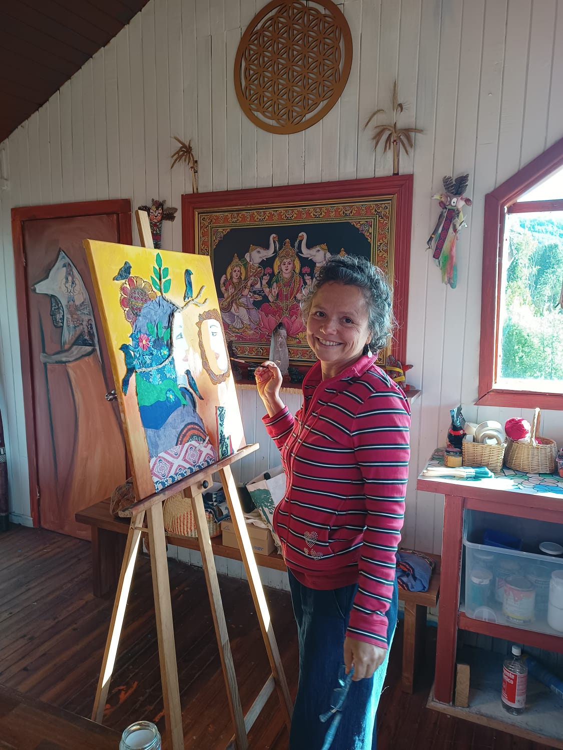 Anahí Sist in her studio, working on a vibrant painting